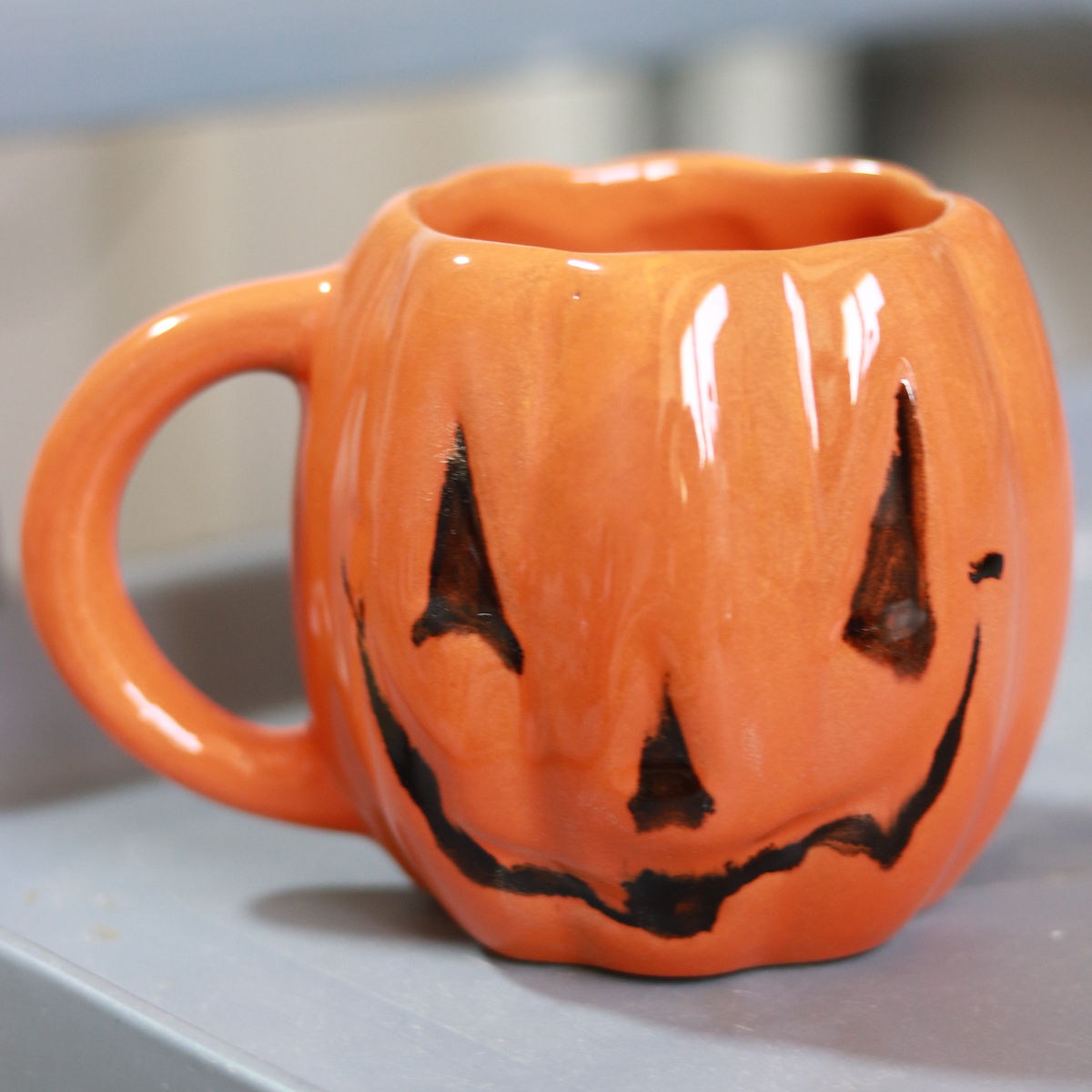 evil pumpkin mug in orange