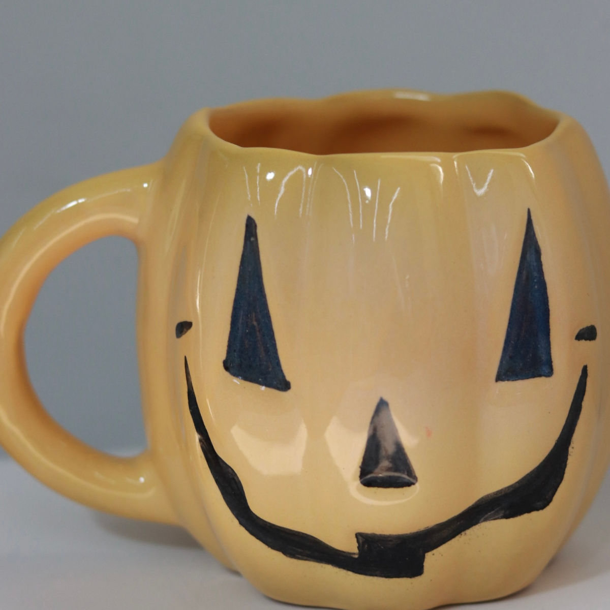 evil pumpkin mug in yellow